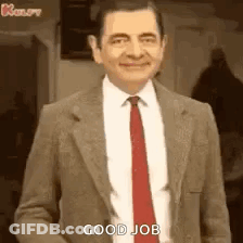 Mr Bean In Suit And Tie Smiling Saying Good Job GIF