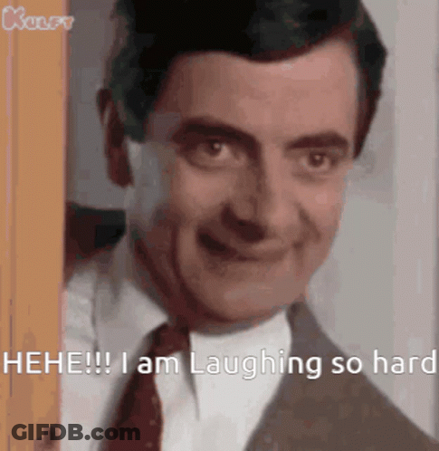 Mr Bean Is Laughing So Hard While Peeking Out Of A Doorway . GIF