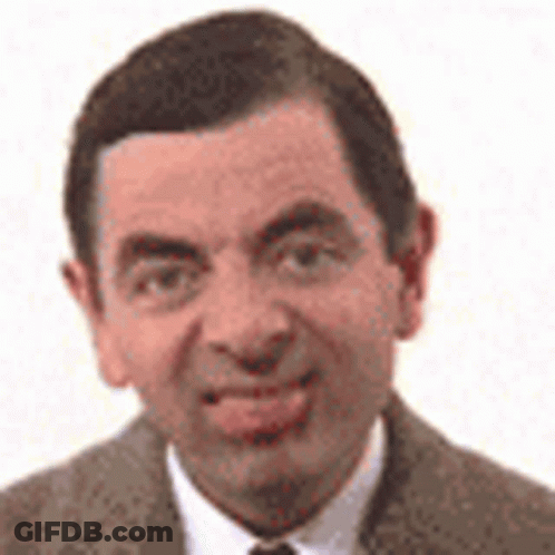 Mr Bean Is Wearing A Suit And Tie And Is Smiling . GIF