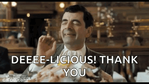 Mr Bean Sitting At Table Making Funny Face GIF