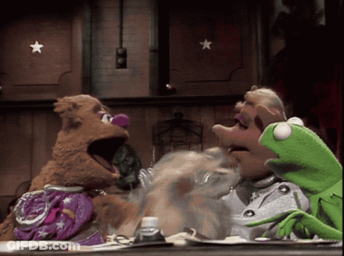 Mrs. Piggy And Kermit Sitting At Table GIF