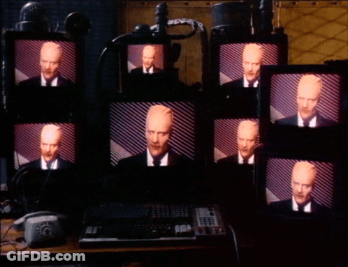 Multiple Monitors With Man In Suit GIF