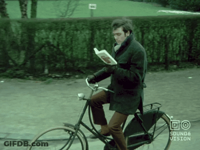 Multitasking Bicycle Ride And Reading GIF
