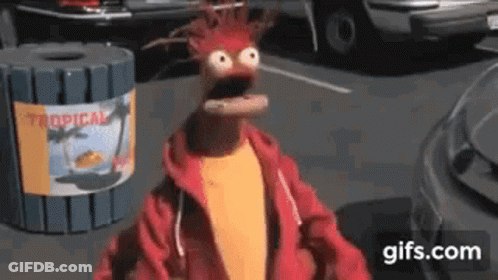 Muppet Standing In Front Of Trash Can With Tropical Sign GIF
