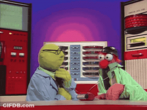 Muppets Talking To Each Other In Front Of A Machine That Says ' A ' On It GIF