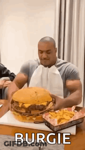 Muscular Man Eating Large Hamburger And French Fries GIF