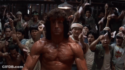 Muscular Man Holding Papers In Front Of Crowd GIF