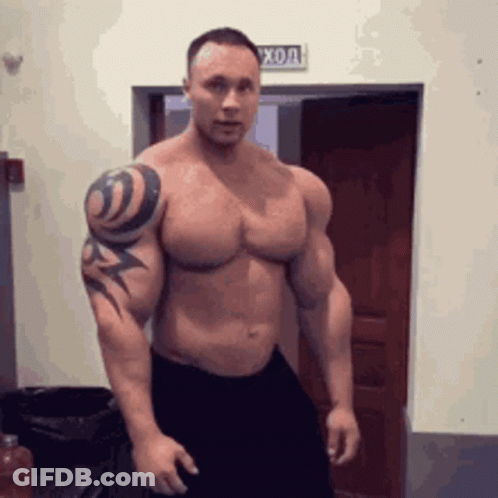 Muscular Man With Tattoo Standing GIF
