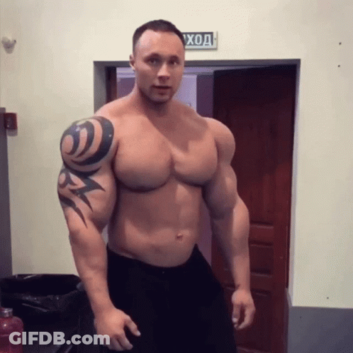 Muscular Man With Tattoo Standing In Front Of Door Saying Вход GIF
