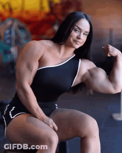 Muscular Woman Sitting And Flexing GIF