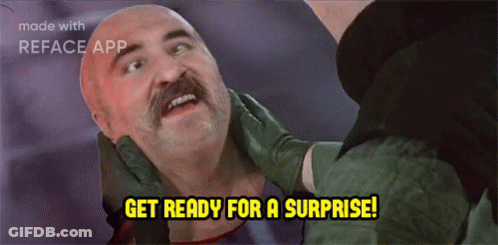 Mustache Man Held By Another Saying Get Ready For A Surprise GIF