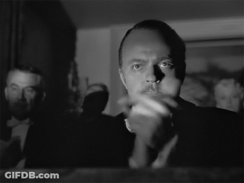 Mustached Man Clapping While Another Watches Black And White GIF