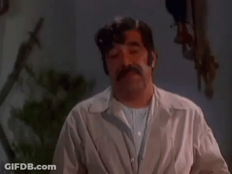 Mustached Man Making Funny Face Dark Room GIF