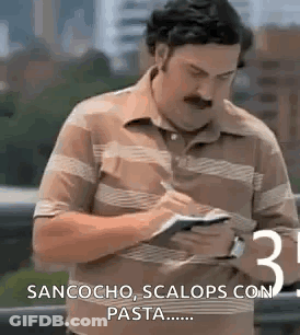 Mustached Man Writing Paper Looking At Phone GIF