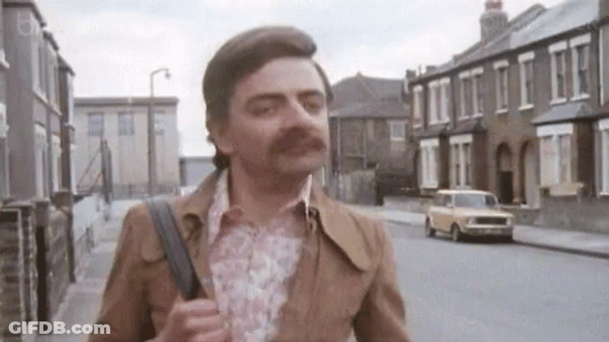 Mustached Rowan Atkinson Striding Happily GIF