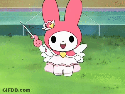 My Melody Is Holding A Wand In Her Hand While Standing On A Lush Green Field . GIF