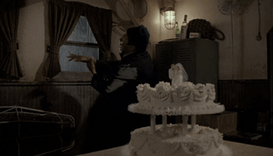 Naked Gun Officer Nordberg Crushing Onto Cake GIF