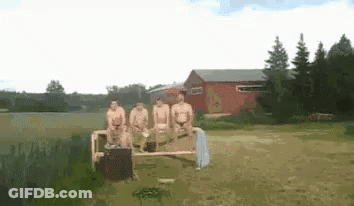 Naked Men Sitting On Bench In Field Near Lake GIF