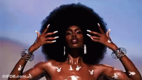 Naked Woman With Large Afro And Playboy Bunny Tattoos GIF