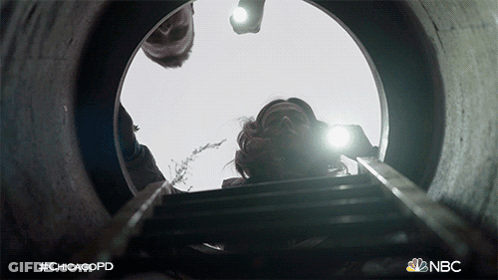 NBC Ad For ChicagoPD Man Looking Out Of Hole GIF