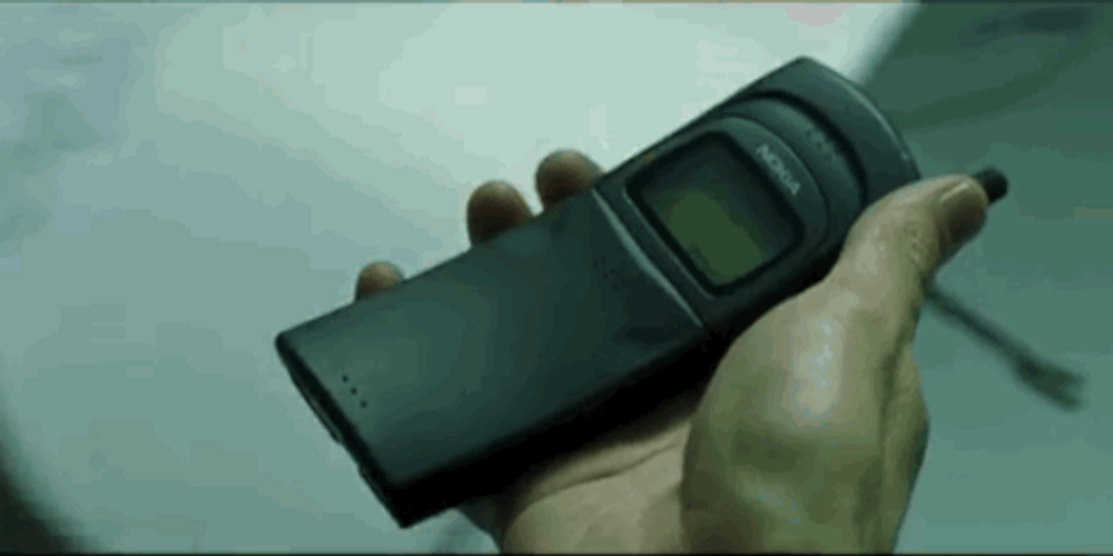 Neo Holding A Phone In Matrix GIF