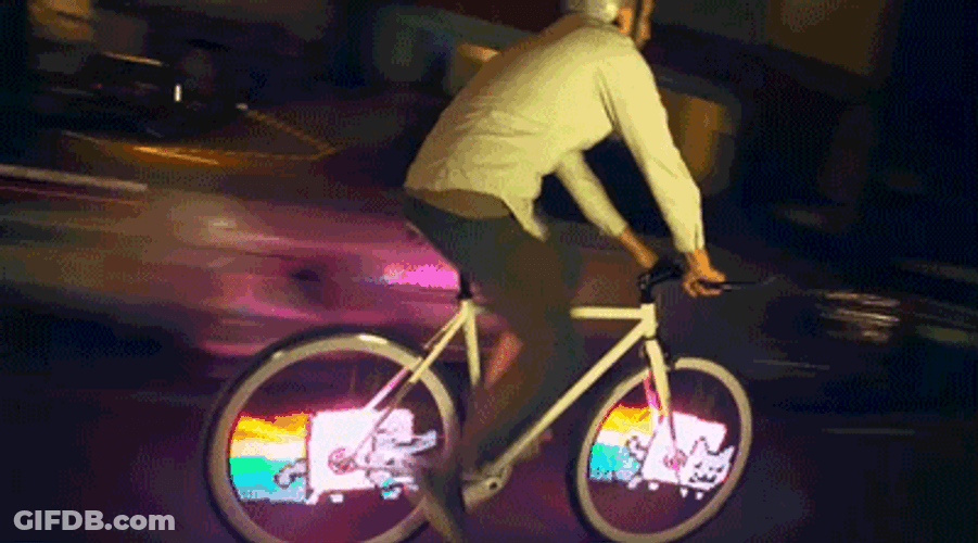 Neon Cat On Bicycle Wheels GIF