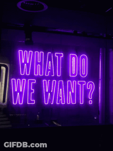 Neon Sign Saying What Do We Want GIF