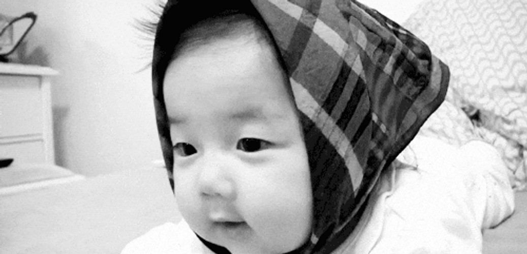 Nepo Baby Wearing Head Covers Smile Sweetly GIF