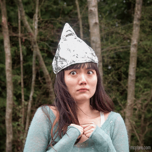 Nervous Lady Wearing Tin Foil Hat GIF