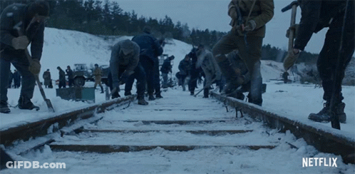 Netflix Ad People Working On Train Tracks In Snow GIF