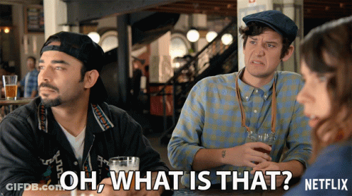 Netflix Ad Showing Two Men Sitting At Table Talking GIF