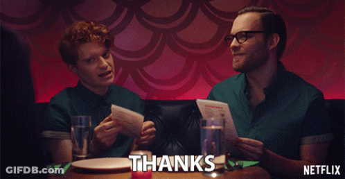 Netflix Ad With Two Men Sitting At Table Holding Menus GIF