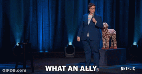 Netflix Ad Woman In Blue Suit Next To Stuffed Animal GIF