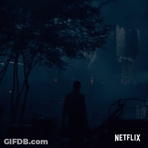 Netflix Man Walking Through Dark Forest GIF