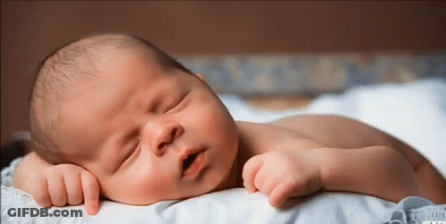 Newborn Baby Sleeping On White Blanket GIF