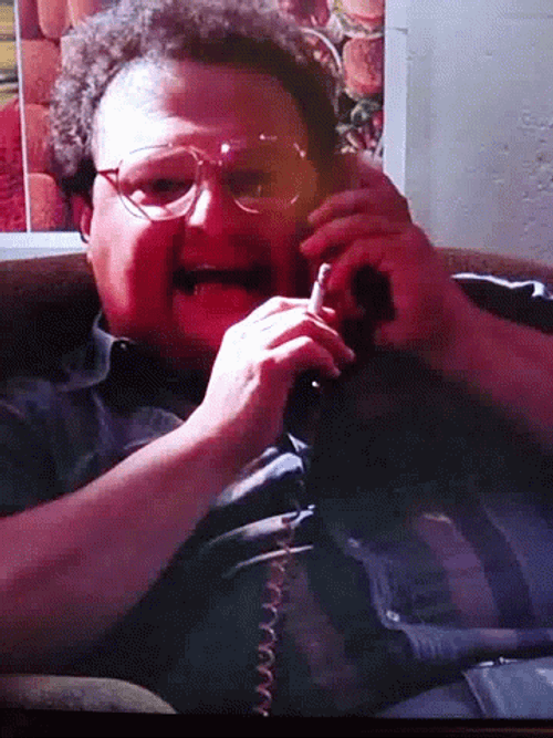 Newman Smoking While Talking On Phone GIF