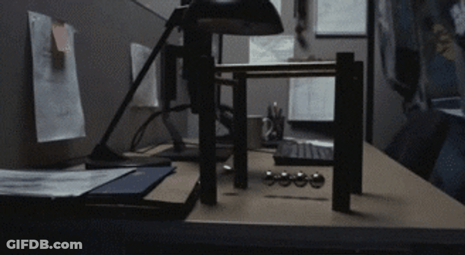 Newton Pendulum On Office Desk GIF