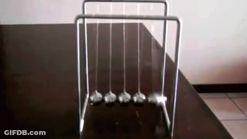 Newton's Cradle On Black Table GIF