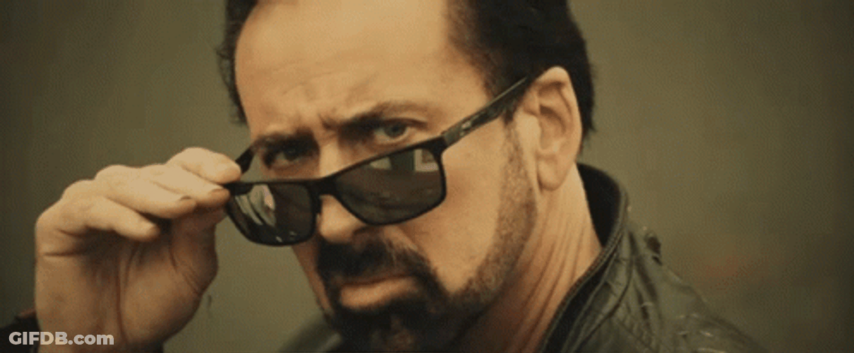 Nic Cage Intense Look Wearing Shades GIF