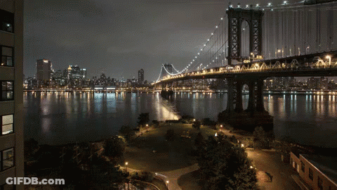 Night Bridge Over Water With City GIF