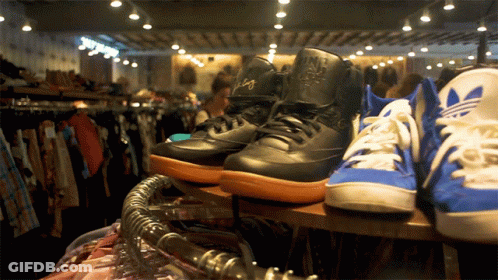 Nike And Adidas Shoes On Shelf GIF