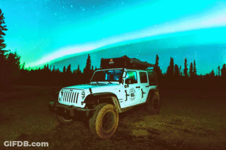 Northern Lights Moment Above A Car GIF
