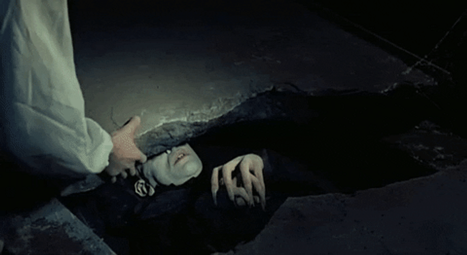 Nosferatu Lying Down Removing The Rock GIF