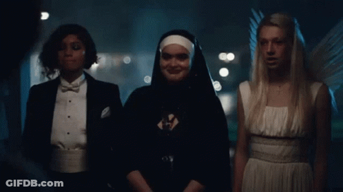 Nun And Two Angels Standing Together GIF