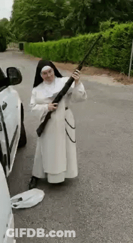 Nun Holding Shotgun Near Car On Roadside GIF