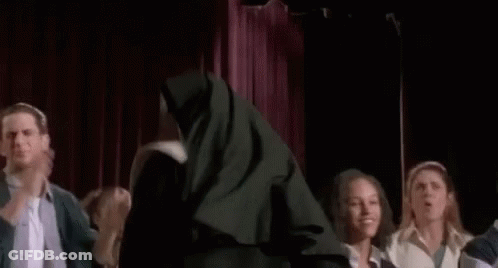Nun Standing In Front Of Group GIF