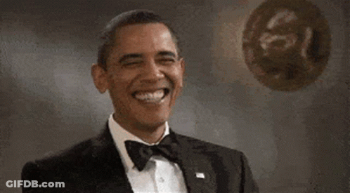 Obama Is Wearing A Tuxedo And Bow Tie And Laughing . GIF