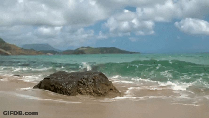 Ocean Waves Against Small Rock GIF