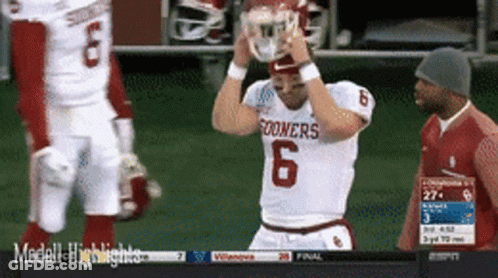 Oklahoma Sooners Football Player Holding Helmet Over Head GIF
