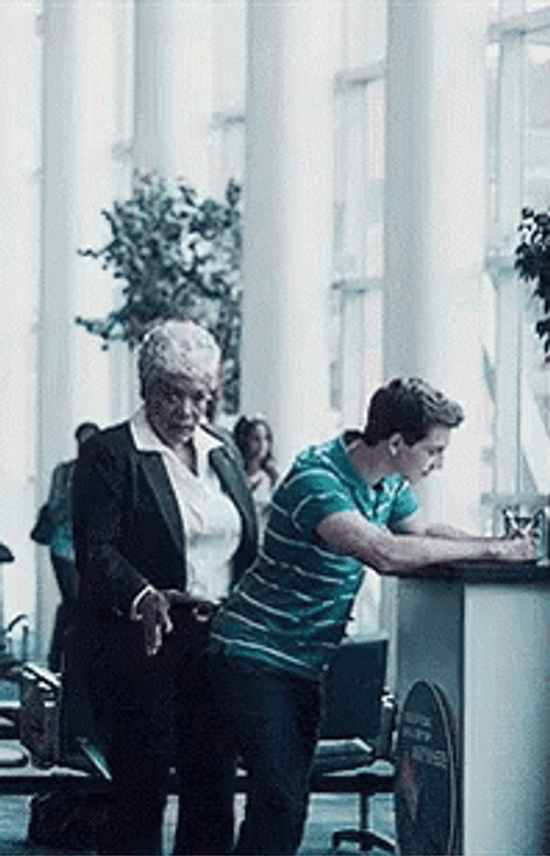 Old Cougar Dancing Behind Young Man GIF